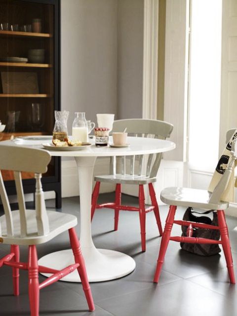 vintage off-white chairs and table and living coral legs give an edgy touch to the space