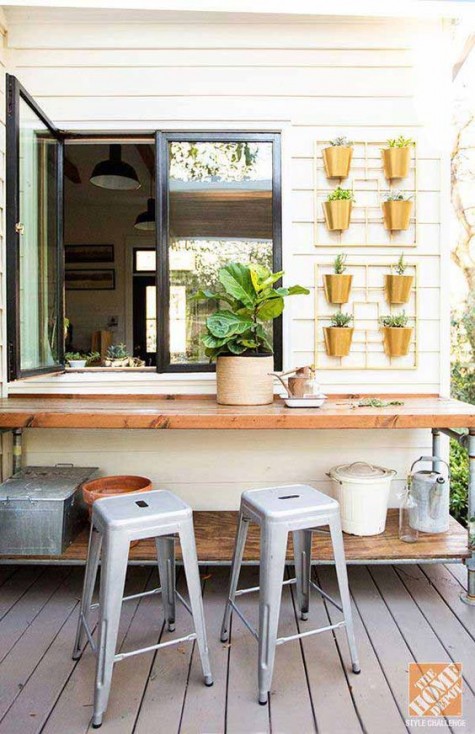 a usual window and a garden table used as a tabletop for a pass through window, a herb garden right on the wall