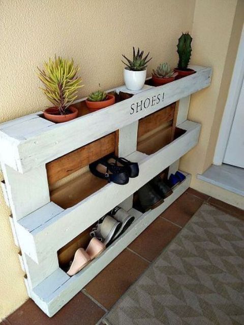 an easy pallet shoe rack in white and with stained parts features shoe storage and storage for pots with succulents