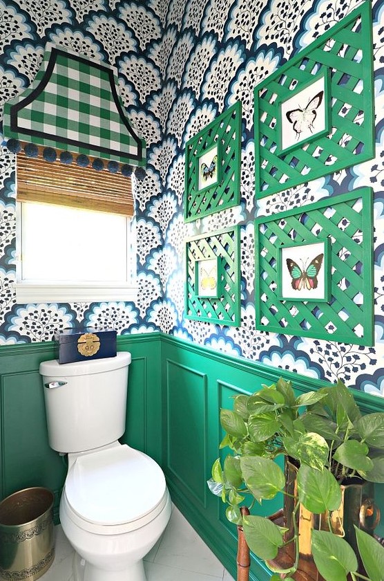 a bold mudroom with green wainscoting, bright printed wallpaper, a bold gallery wall with green frames and a curtain plus metallic touches