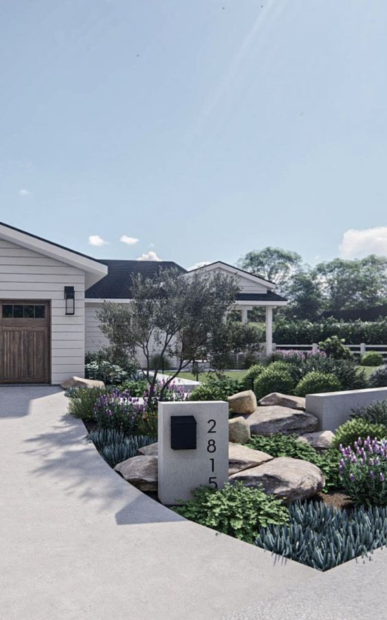 a chic modern front yard designed with rocks, greenery and shrubs, purple blooms and a tall tree looks cool and lovely