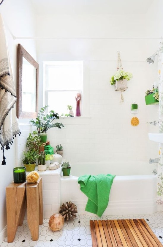 a contemporary meets boho bathroom with wooden touches, lots of potted greenery and blooms and decor