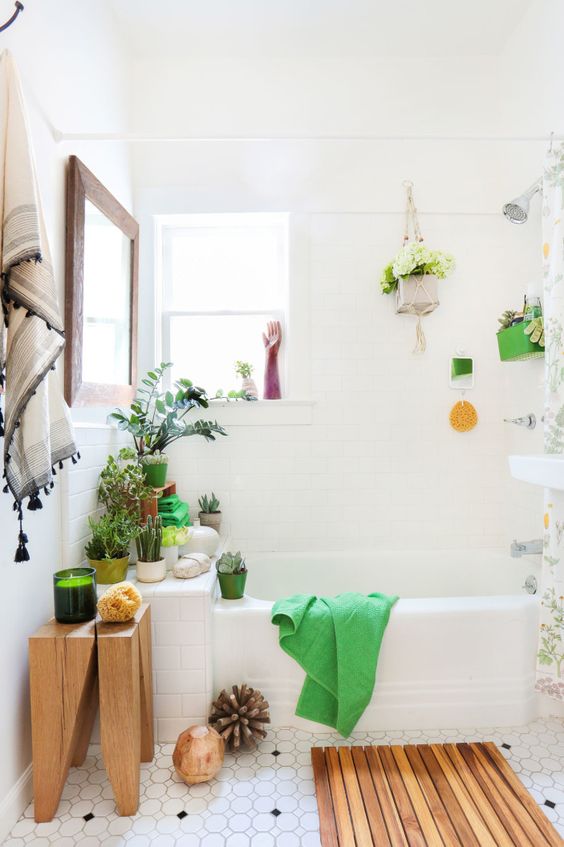 a contemporary meets boho bathroom with wooden touches, lots of potted greenery and blooms and decor