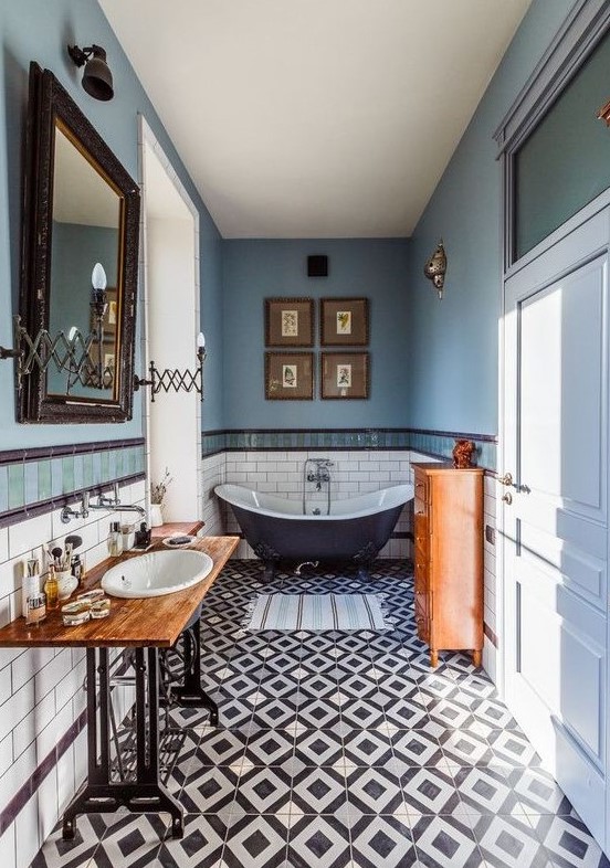 a gorgeous eclectic bathroom done in the shades of blue and copper, with lots of vintage items and furniture