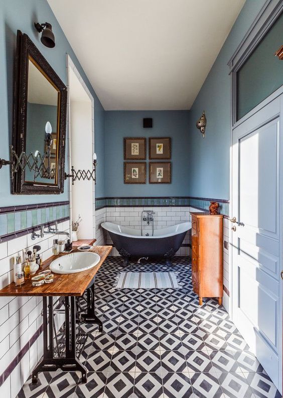 a gorgeous eclectic bathroom done in the shades of blue and copper, with lots of vintage items and furniture