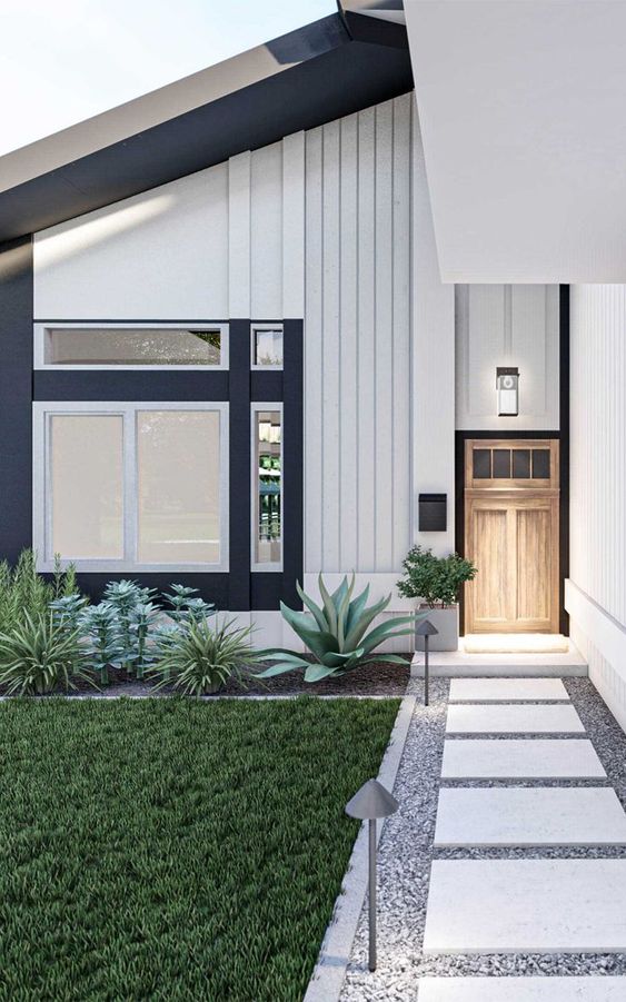 a lovely modern front yard with gravel and stone tiles, a green lawn, agaves and succulents plus potted greenery