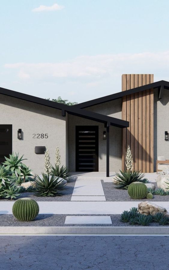 a modern drought tolerant front yard with gravel and stone, oversized agaves, cacti and some blooms is super cool