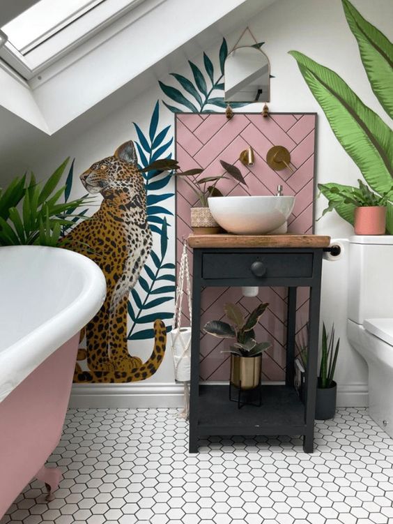 an attic bathroom with white walls and hex tiles, bold walll mural, a pink bathtub, a black vanity with a bowl sink