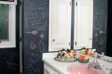 an eclectic bathroom with a vintage vanity and chalkboard walls to inspire kids’ art and playing