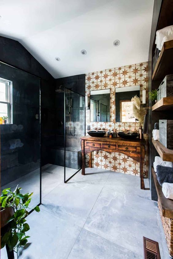 an eclectic bathroom with dark walls in the shower and star printed ones, a vintage vanity with two sinks and greenery