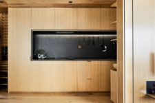 wooden cabinets and a black marble backsplash is an awesome mix