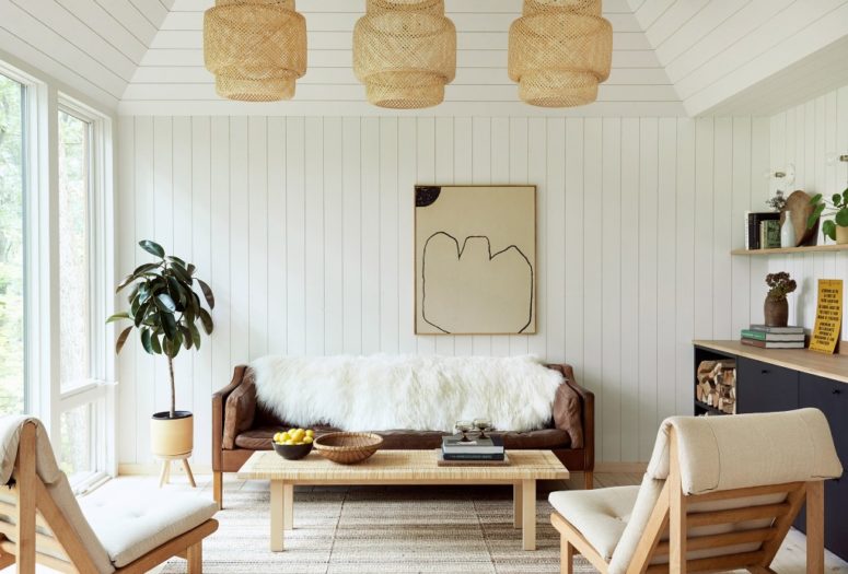 an interior with wicker decor touches The space is done with wooden planks and a simple color scheme - navy, white, light-colored wood and wicker touches