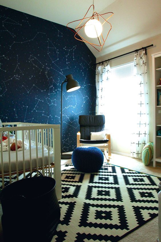 a starry nursery can be accented with navy constellation wallpaper on one of the walls