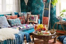 04 colorful and bright printed pillows and a blanket plus a rug and a faux fur piece make up the whole space