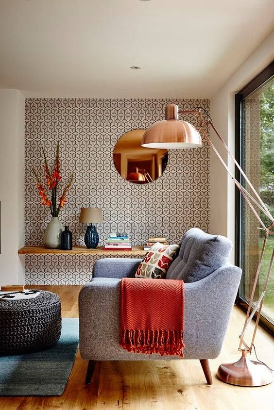 a mid-century modern living room accented with catchy printed wallpaper on one of the walls