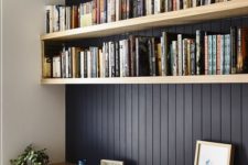 07 a stylish contemporary home office with black vertical shiplap on the statement wall and light stained wooden furiture