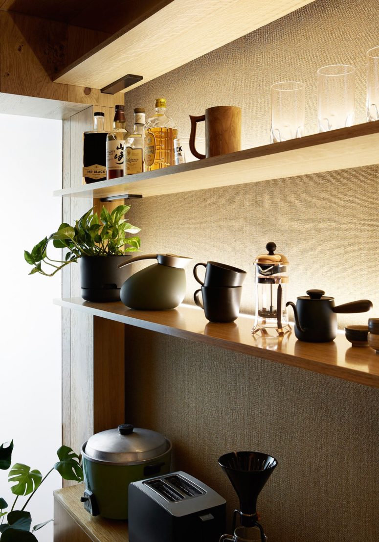 The kitchen shows off a comfortable open shelving unit with all the necesary things