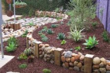 09 a gabion wall used as garden edging blends with the natural environment making it fresh and cool