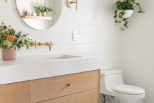 09 an airy contemporary meets boho bathroom with white shiplap, a light stained vanity, potted greenery and a round mirror