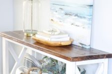 10 a rustic meets modern console table in white and with a rich stained tabletop for a coastal entryway