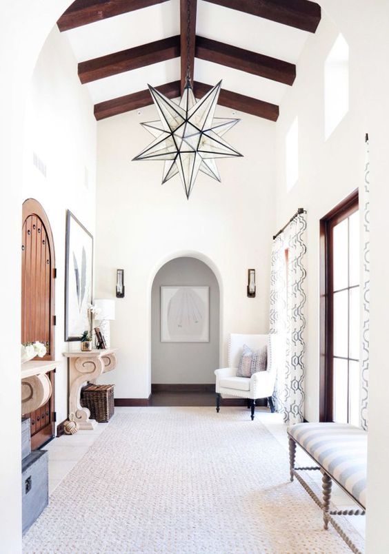 a neutral and light-filled entryway with an oversized star-shaped chandelier for a statement