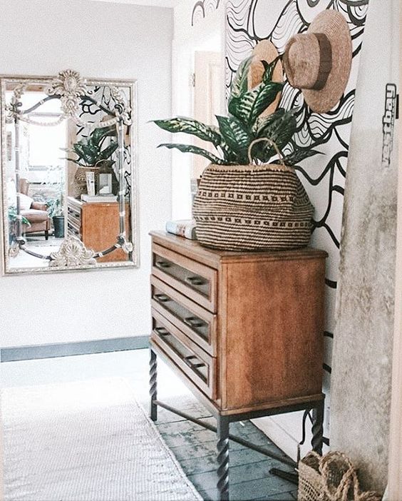 a vintage dresser with swirl legs and inlaid drawers for a contemporary coastal home with a boho feel