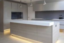 12 lower cabinets and the kitchen island highlighted with strip lighting is a hot idea for an edgy kitchen look