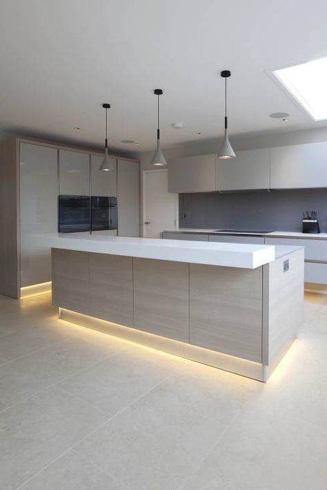 lower cabinets and the kitchen island highlighted with strip lighting is a hot idea for an edgy kitchen look