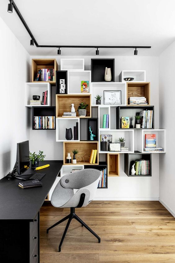 mismatching box wall-mounted shelving units double as decoration in a home office