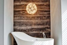 17 a free-standing bathtub of a catchy shape is a bold and cool idea for a bathroom