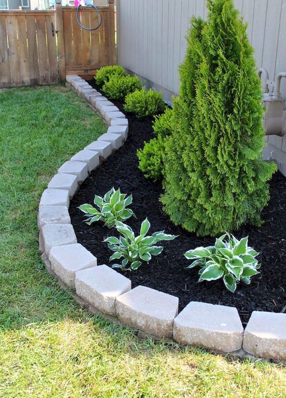 simple brick garden edging to highlight the raised garden bed and separate it from the lawn