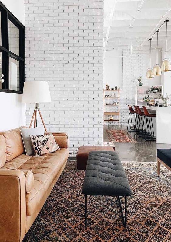 white brick walls in an open layout tie up the spaces and make the whole layout more cohesive