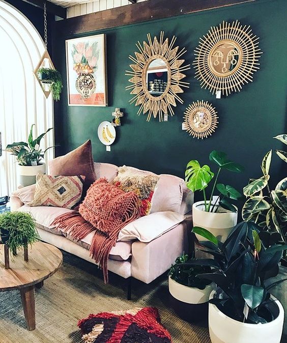 an arrangement of gold mirrors and sun art pieces is ideal for decorating a boho home