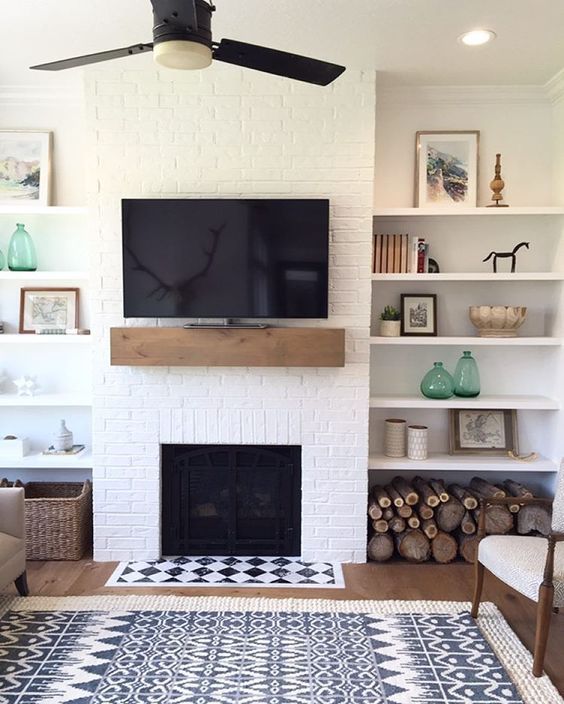 a farmhouse living room with a white brick wall and touches of wood and wicker for coziness