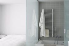 23 placing a bathtub into the bedroom and separating the zone with glass wall is a cool way to save the space