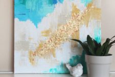 24 a bright artwork done with gold and gold glitter touches is a brigth idea to spruce up the space