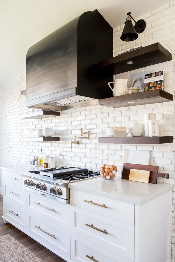 a chic farmhouse kitchen with a white brick statement wall that also acts as a kitchen backsplash