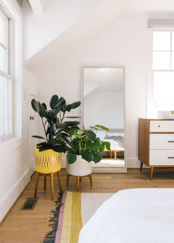 bright plants in colorful planters on wooden stands will make your space more outdoor-like