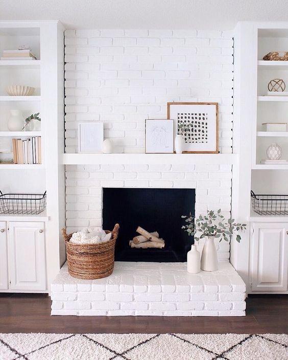 a farmhouse living room with a white brick clad fireplace to accent it and all neutrals around