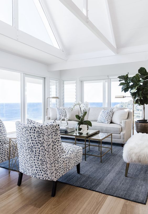 potted greenery here and there and white orchids make this living room feel luxurious and fresh