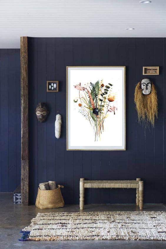 an eclectic entryway with vertical navy shiplap plus a wooden beam to highlight it and catchy decor