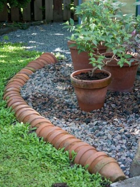 a terra cotta pot garden border is a nice idea for a relaxed and rustic garden with vintage touches