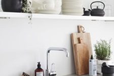 a concrete countertop and a neutral kitchen sink make up a chic and bold combo for a minimalist kitchen