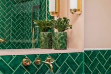 a glossy pink vessel sink adds an unexpected touch to this bright green bathroom, and gold touches brighten the space up