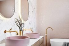 two round pink corian vessel sinks add color to the space and make it look more girlish