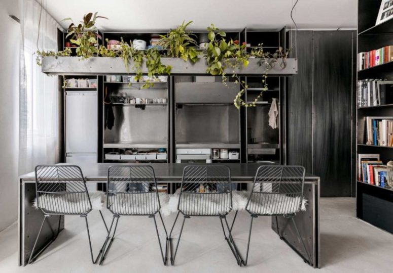 The kitchen is done with metal, all the appliances, a metal table and chairs plus a concrete planter over it The kitchen is done with metal, all the appliances, a metal table and chairs plus a concrete planter over it