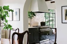 02 an arched doorway leading to the kitchen hints on vintage style and touches of Spanish colonial decor you’ll see