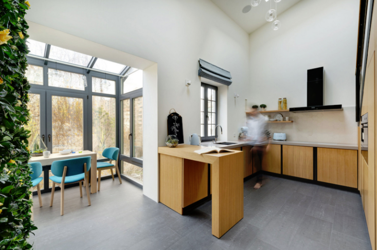 kitchen is done with wooden cabinets The kitchen is small and is done with wooden cabinets, a large storage unit and it gently flows into the dining area