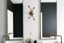 03 a bold art deco bathroom with white skinny tiles clad in a chevron pattern and a terrazzo floating vanity