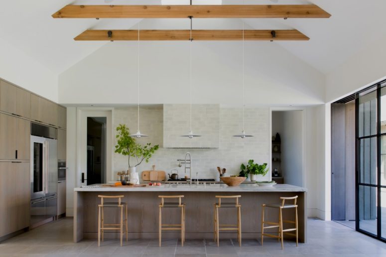 super large kitchen island with dining area The kitchen is done with a large kitchen island that provides cooking space and a meal space, too
